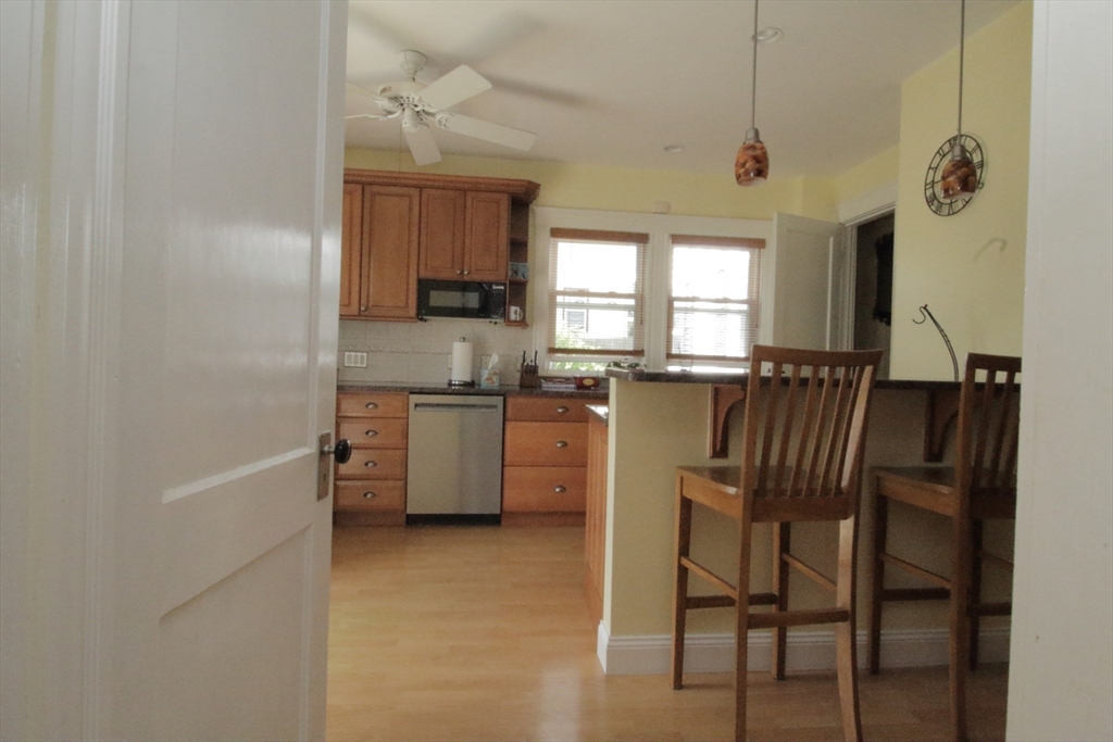 36 Kimball Road Chelsea, MA 02150 - Photo 7 of 24 a kitchen with a table chairs refrigerator and microwave