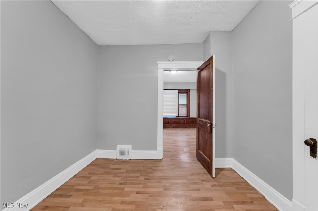 4408 Alpha Avenue Cleveland, OH 44105 - Photo 39 of 41 Spare room featuring light hardwood / wood-style floors and a textured ceiling
