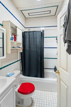 a bathroom with a sink a bath tub and a toilet