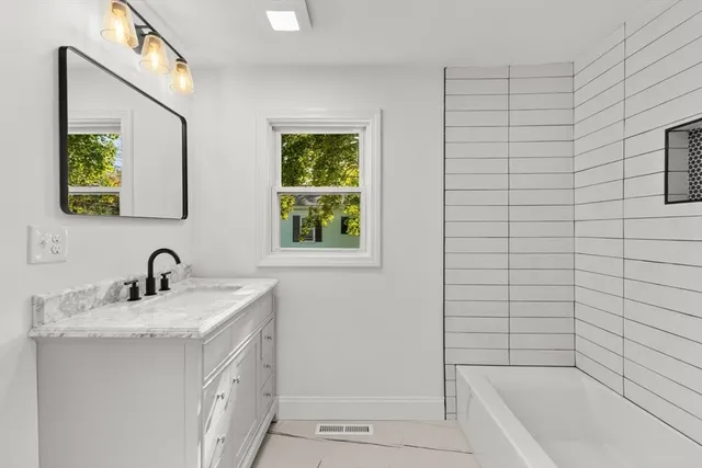 a utility room with a sink a toilet and a window