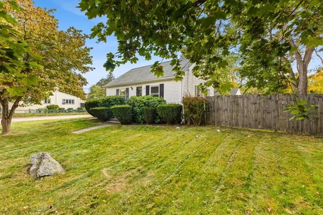 a view of a house with pool and a yard