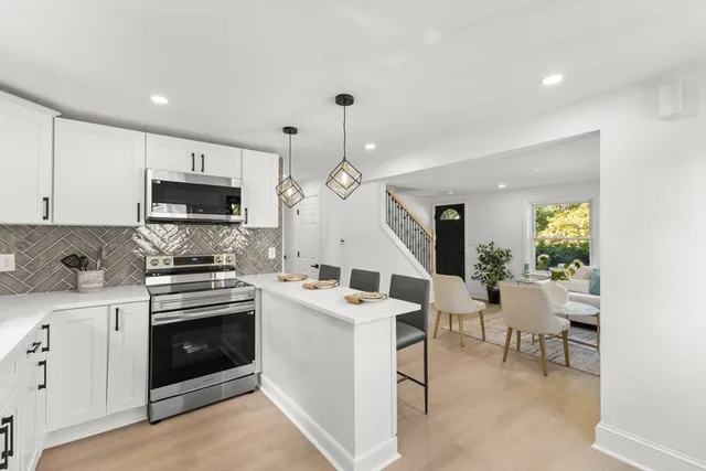 a kitchen with a sink stove and microwave