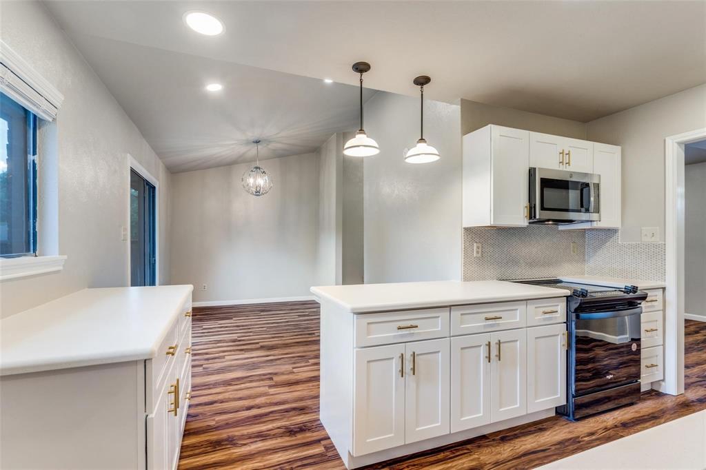 7904 Simpkins Place Plano, TX 75025 - Photo 14 of 24 a kitchen with stainless steel appliances white cabinets and sink