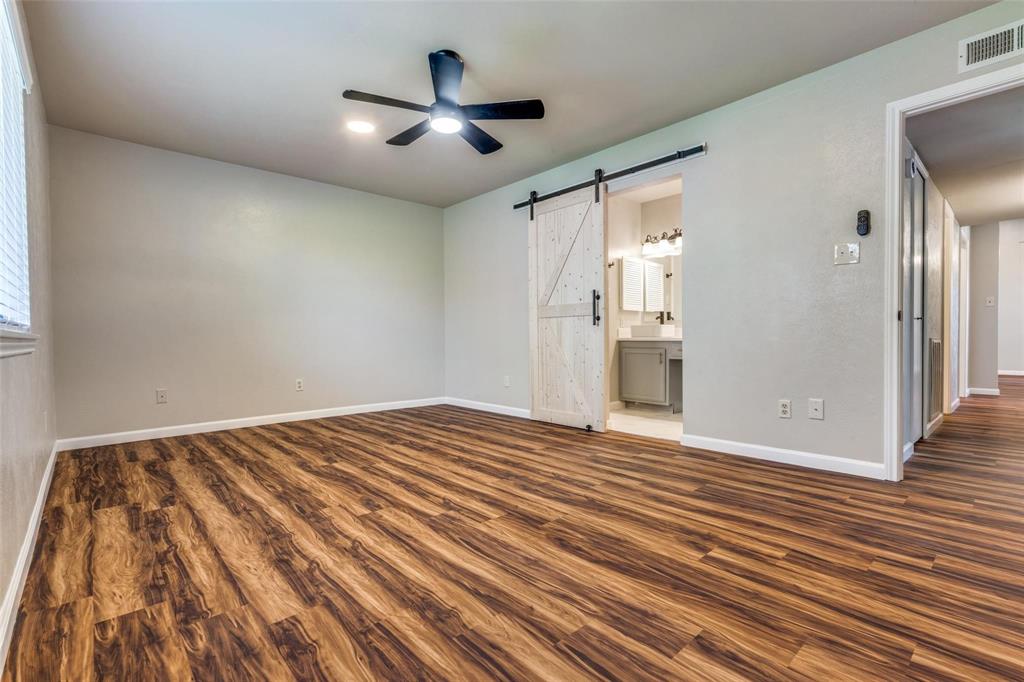7904 Simpkins Place Plano, TX 75025 - Photo 16 of 24 a view of an empty room with wooden floor and a window