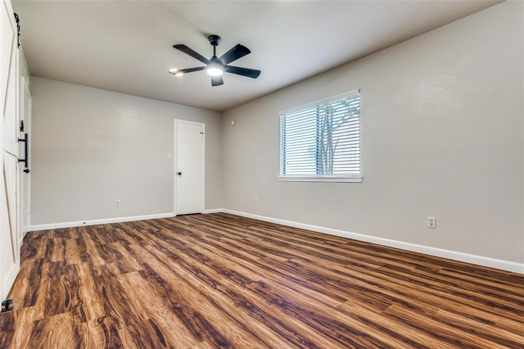 7904 Simpkins Place Plano, TX 75025 - Photo 17 of 24 a view of a livingroom with wooden floor and a ceiling fan