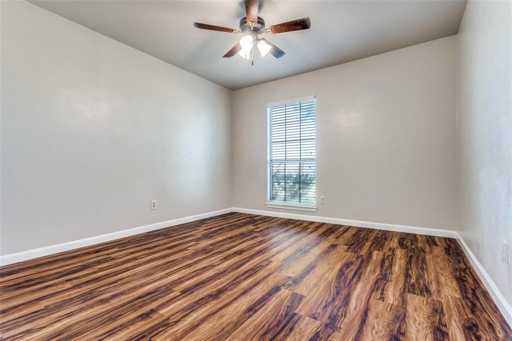 7904 Simpkins Place Plano, TX 75025 - Photo 21 of 24 a view of an empty room with wooden floor and a window