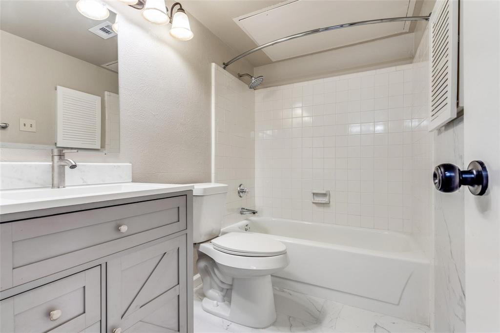 7904 Simpkins Place Plano, TX 75025 - Photo 22 of 24 a bathroom with a bathtub shower sink vanity and toilet
