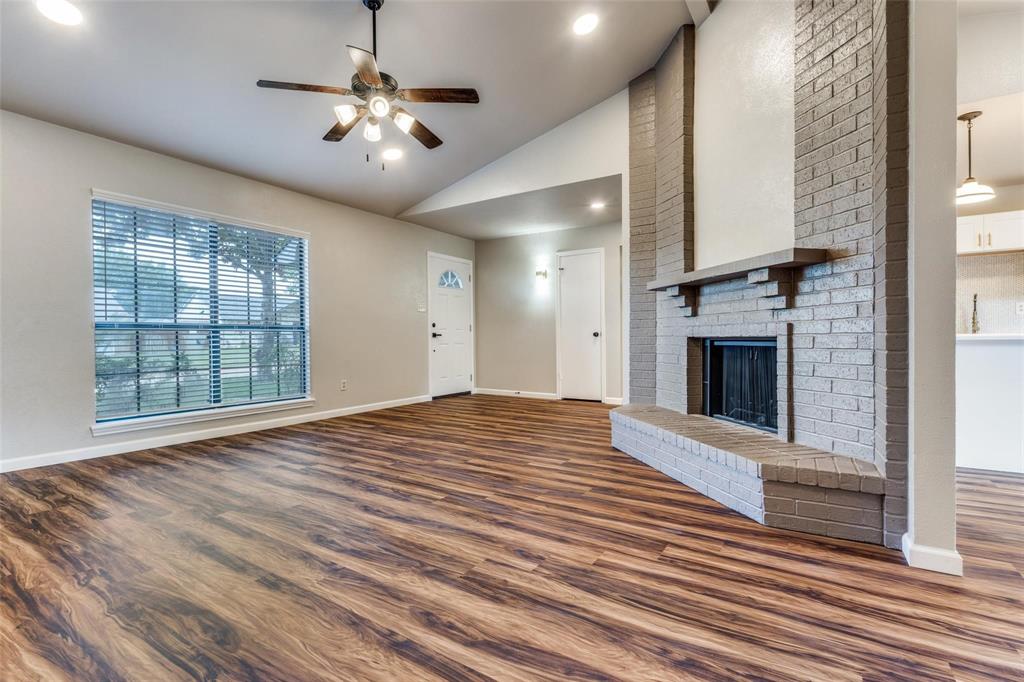 7904 Simpkins Place Plano, TX 75025 - Photo 4 of 24 a view of an empty room with a fireplace and a window
