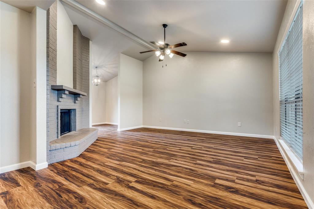 7904 Simpkins Place Plano, TX 75025 - Photo 5 of 24 wooden floor in an empty room with a fireplace