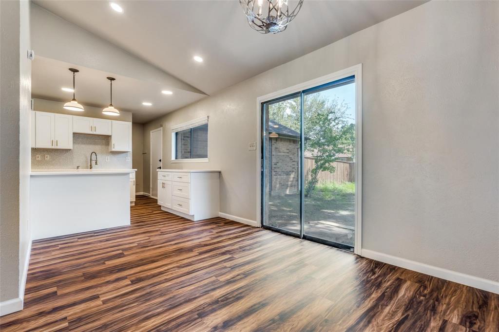 7904 Simpkins Place Plano, TX 75025 - Photo 9 of 24 a view of a kitchen with wooden floor and a window