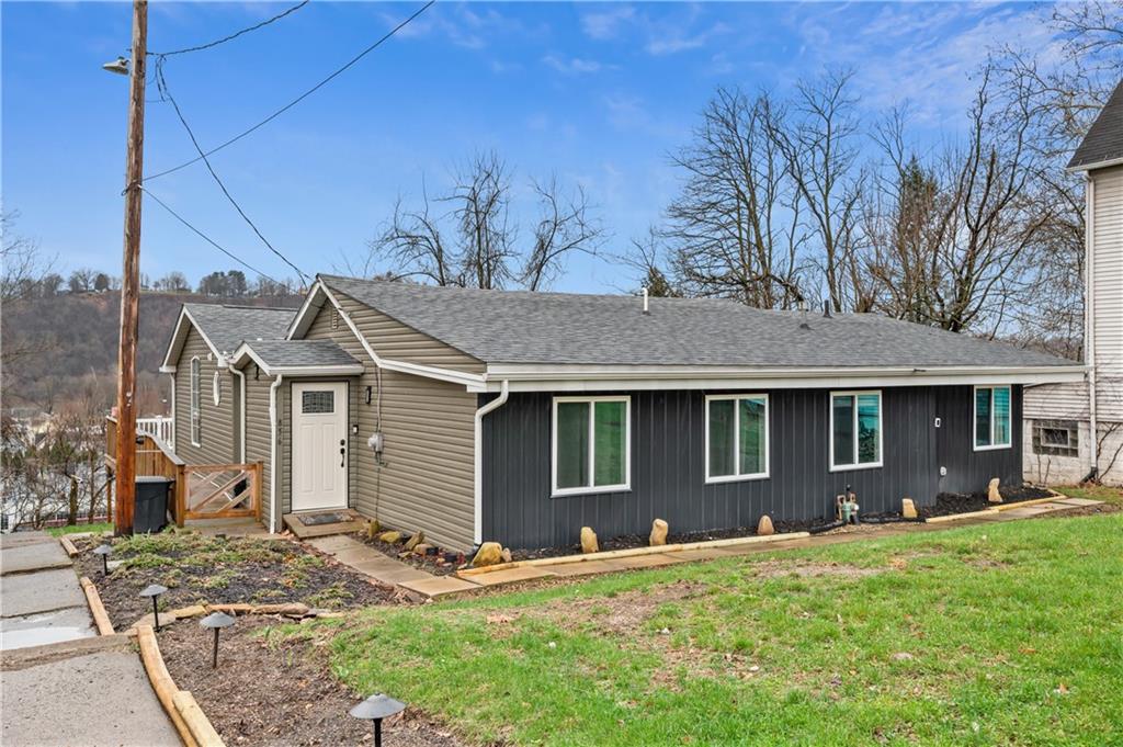 856 Cleveland Avenue Brackenridge, PA 15014 - Photo 2 of 35 a front view of a house with a yard and garage