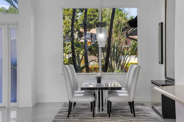 a living room with stainless steel appliances furniture and a view of kitchen