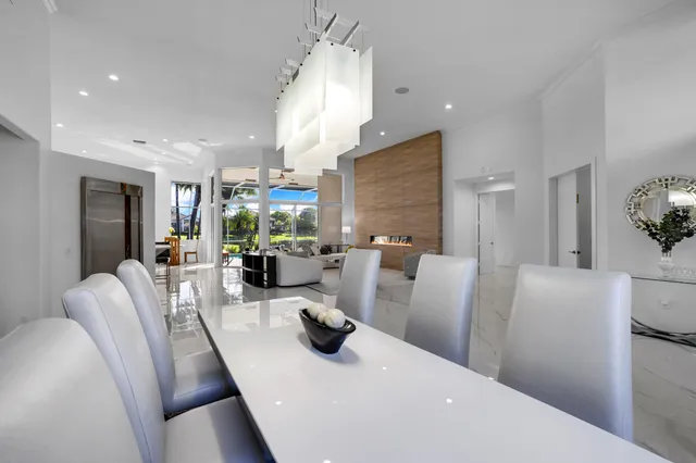 a kitchen with stainless steel appliances a sink a counter top space cabinets and a potted plant