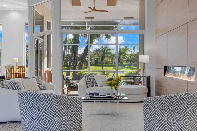 a living room with furniture and a floor to ceiling window