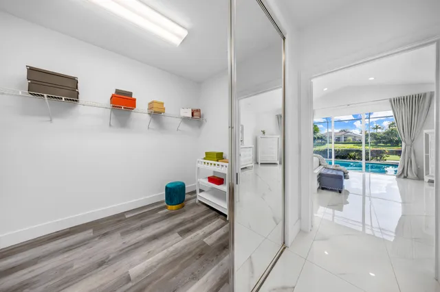 a view of a chair and tables in the back yard of the house