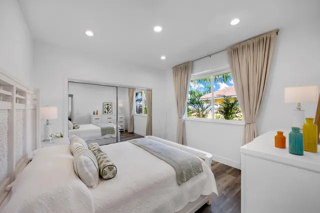 a view of a house with a yard and potted plants