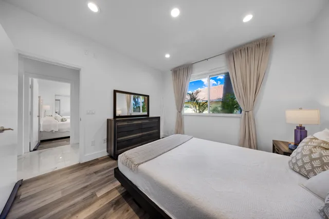 a view of a house with a big yard and potted plants