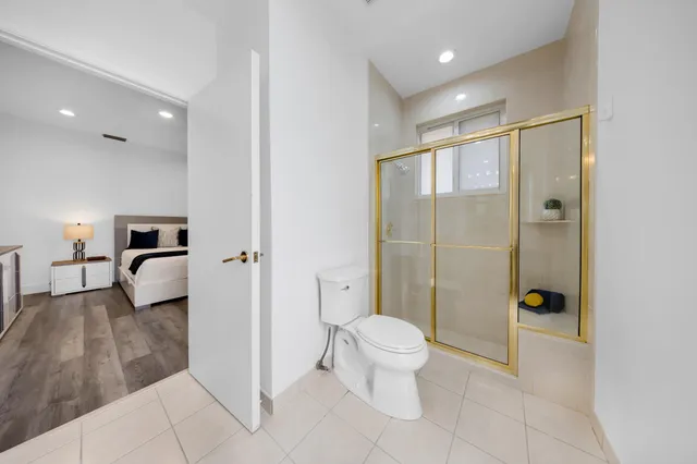 a front view of a house with a garden and trees