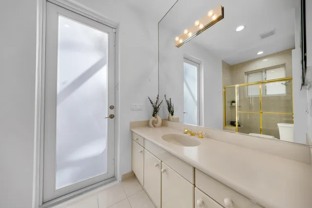 a view of a house with a yard and palm trees