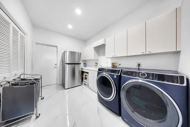 a view of house with a yard and potted plants