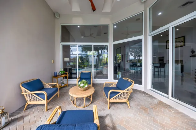 a front view of a house with swimming pool having outdoor seating