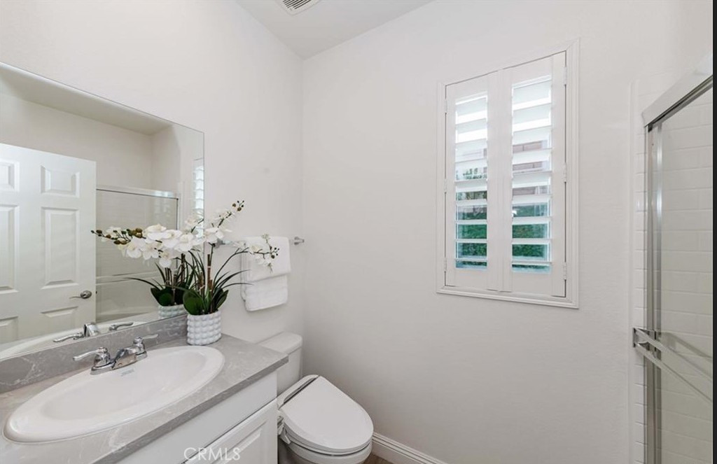 20886 Mountain Gate Drive Riverside, CA 92507 - Photo 18 of 27 a bathroom with a sink toilet and shower