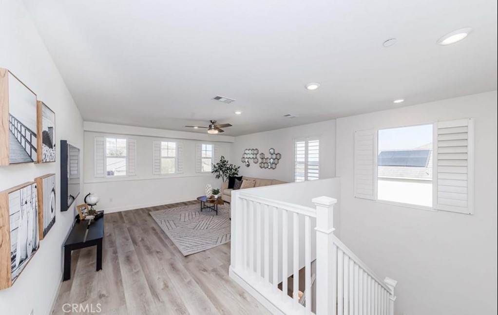 20886 Mountain Gate Drive Riverside, CA 92507 - Photo 20 of 27 a view of a livingroom with furniture hardwood floor and a ceiling fan