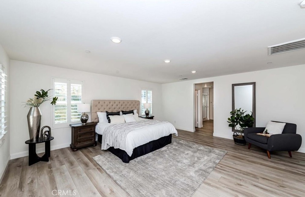 20886 Mountain Gate Drive Riverside, CA 92507 - Photo 21 of 27 a bedroom with a bed and wooden floor