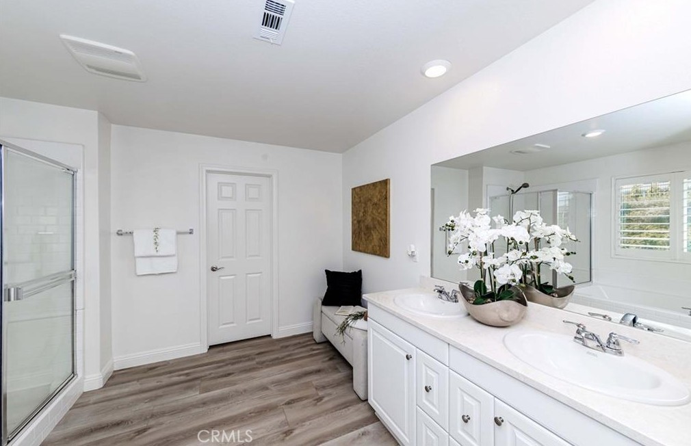 20886 Mountain Gate Drive Riverside, CA 92507 - Photo 22 of 27 a bathroom with a double vanity sink and a mirror