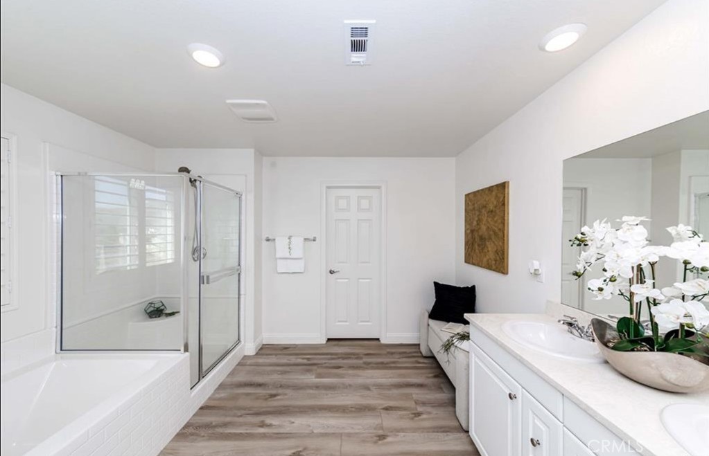 20886 Mountain Gate Drive Riverside, CA 92507 - Photo 23 of 27 a bedroom with a bed and a chandelier