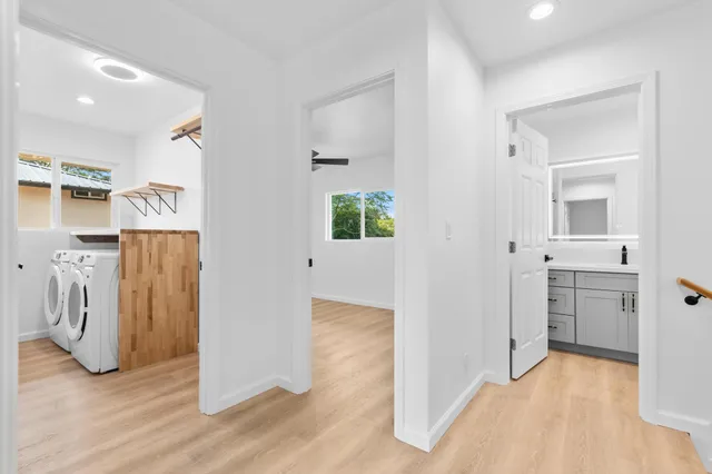 a view of a kitchen with a sink and a refrigerator