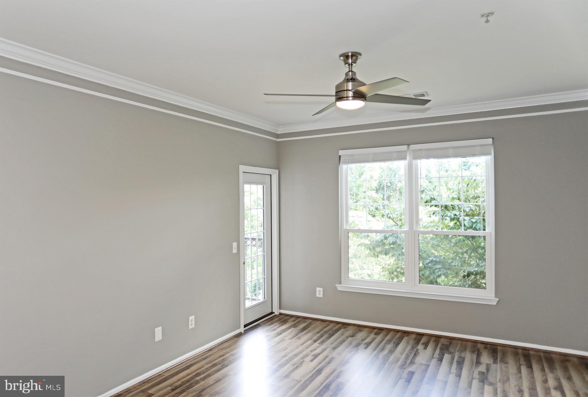 1601 Spring Gate Dr., Unit 1202 McLean, VA 22102 - Photo 11 of 30 a view of an empty room with wooden floor and a window