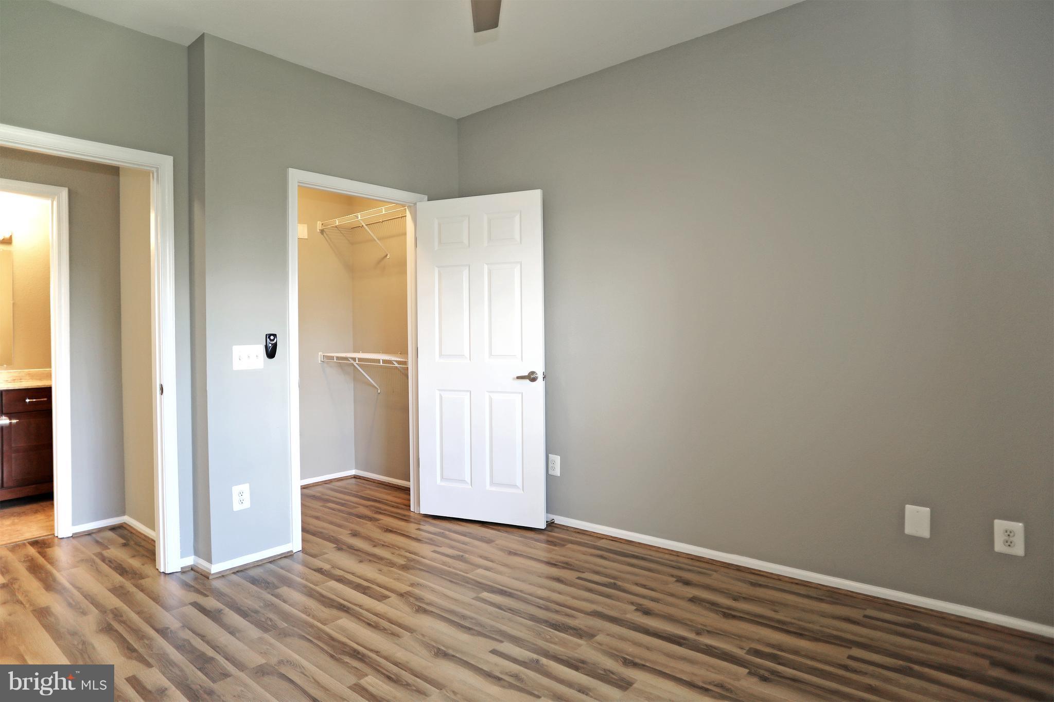1601 Spring Gate Dr., Unit 1202 McLean, VA 22102 - Photo 15 of 30 a view of a room with wooden floor and a bathroom