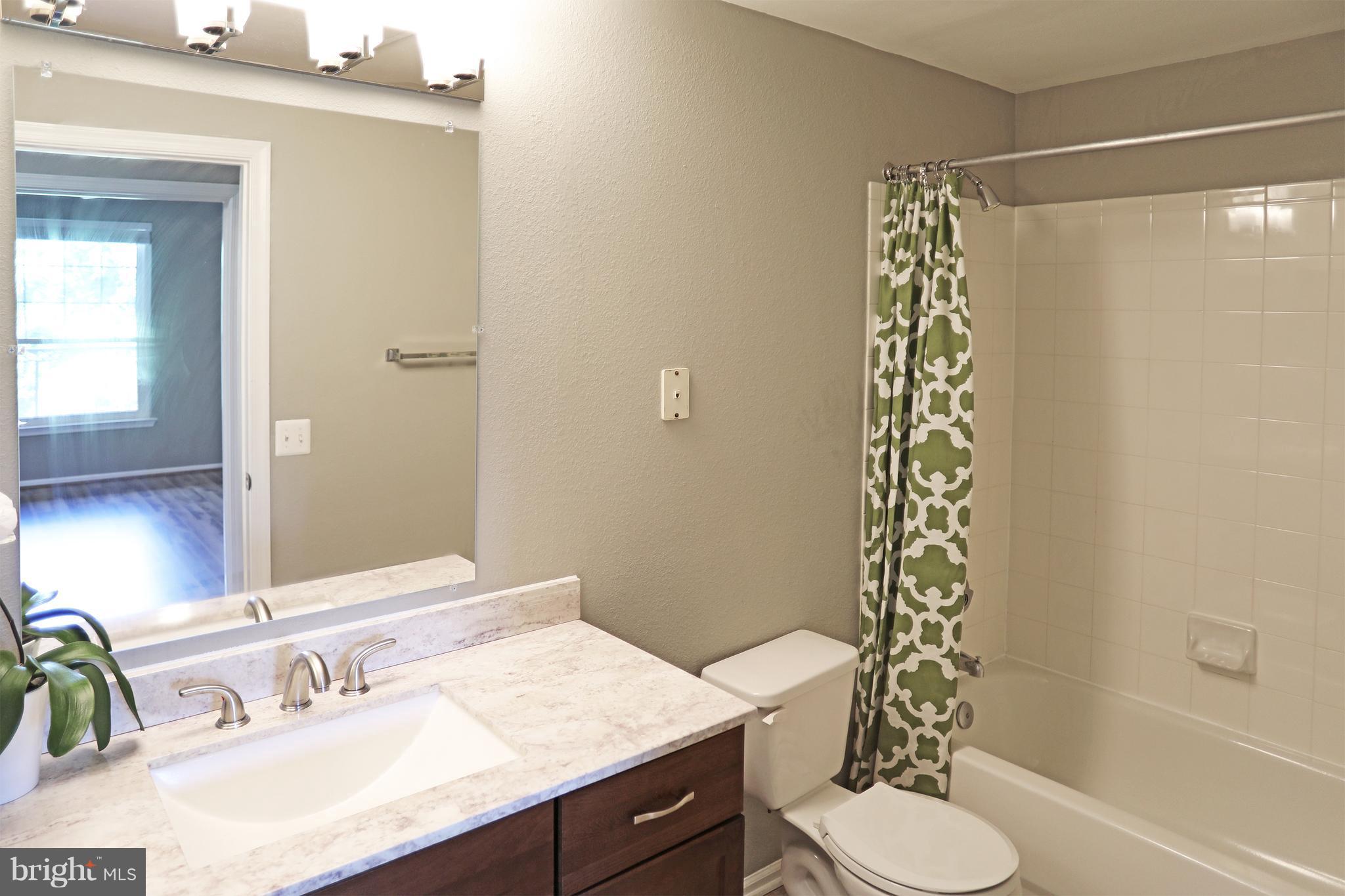 1601 Spring Gate Dr., Unit 1202 McLean, VA 22102 - Photo 18 of 30 a bathroom with a sink toilet and shower