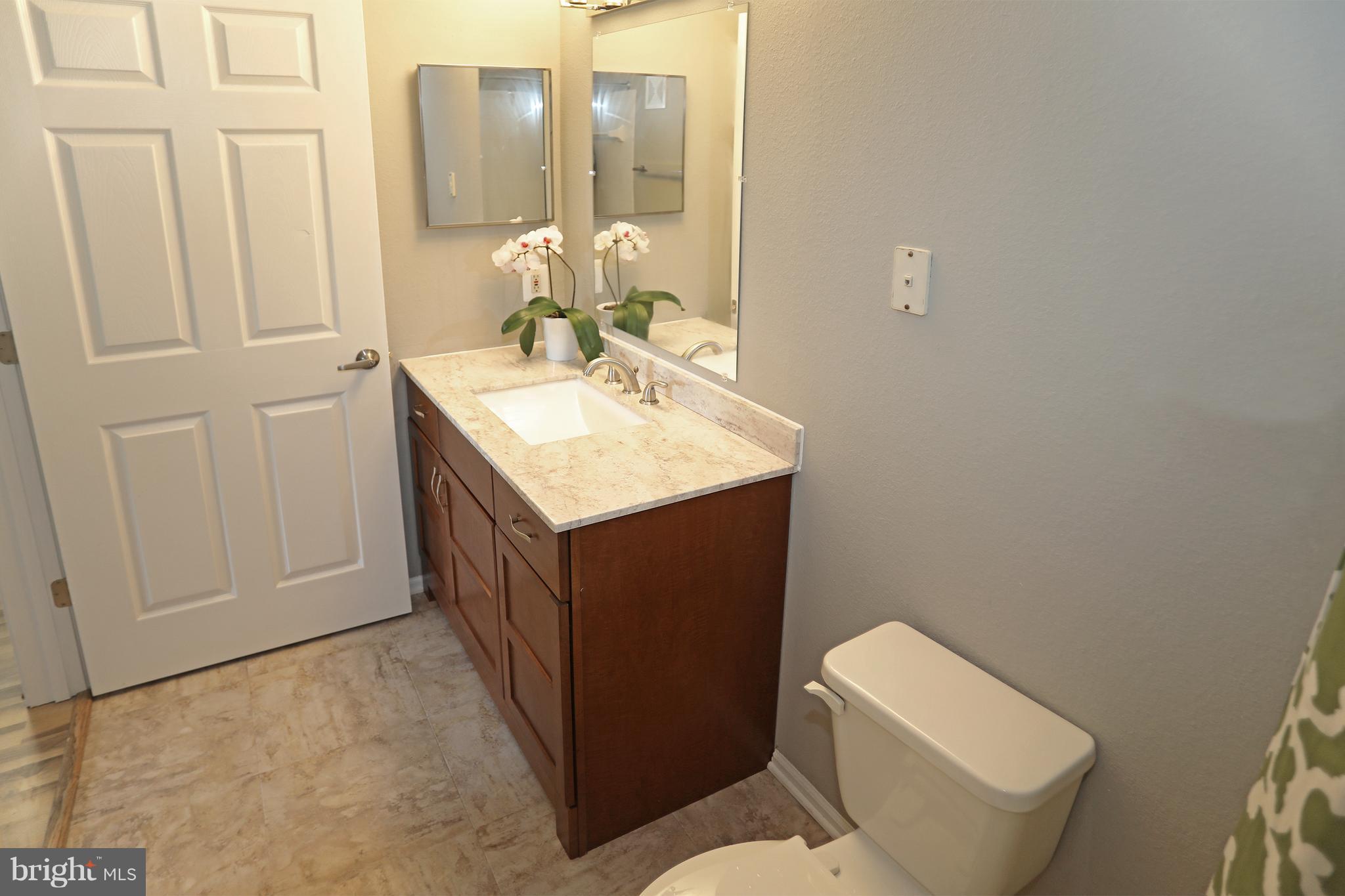 1601 Spring Gate Dr., Unit 1202 McLean, VA 22102 - Photo 19 of 30 a bathroom with a toilet sink and mirror