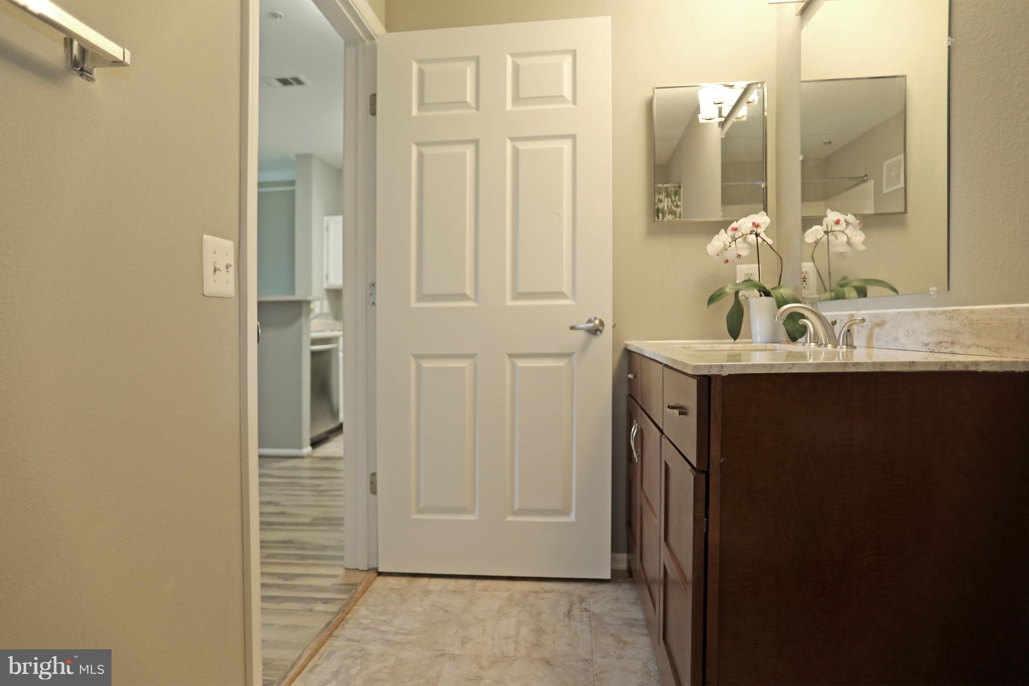 1601 Spring Gate Dr., Unit 1202 McLean, VA 22102 - Photo 20 of 30 a bathroom with a sink and a mirror