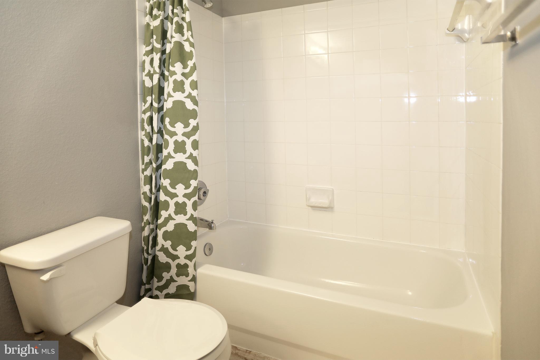 1601 Spring Gate Dr., Unit 1202 McLean, VA 22102 - Photo 21 of 30 a white toilet sitting next to a bath tub