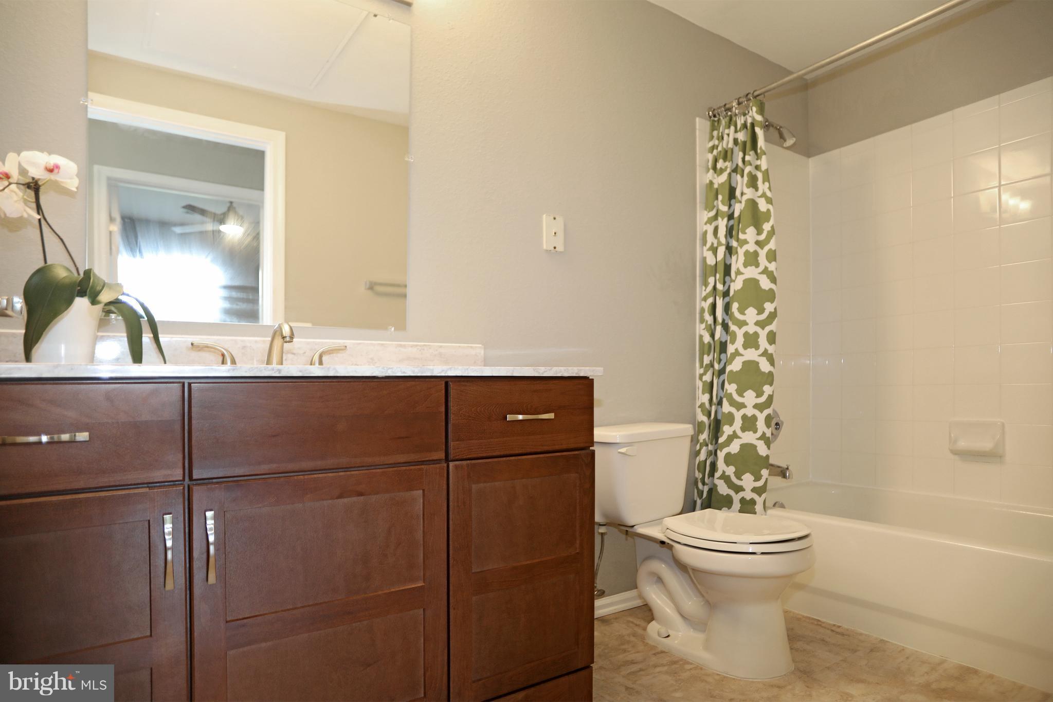 1601 Spring Gate Dr., Unit 1202 McLean, VA 22102 - Photo 22 of 30 a bathroom with a sink a toilet and shower