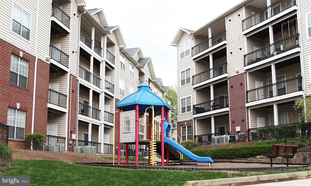 1601 Spring Gate Dr., Unit 1202 McLean, VA 22102 - Photo 30 of 30 a front view of buildings with yard and trees