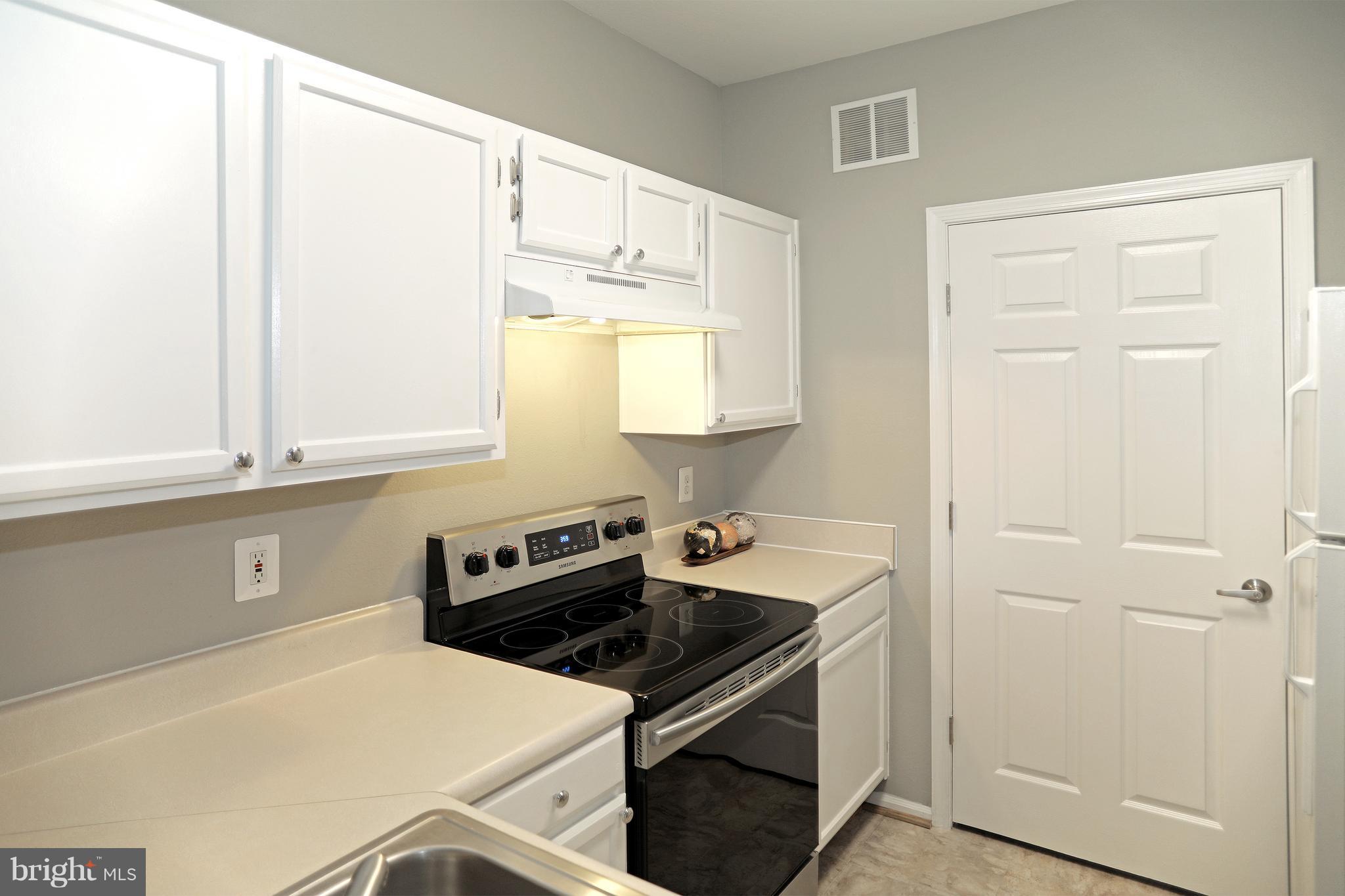 1601 Spring Gate Dr., Unit 1202 McLean, VA 22102 - Photo 6 of 30 a kitchen with a sink stove and cabinets