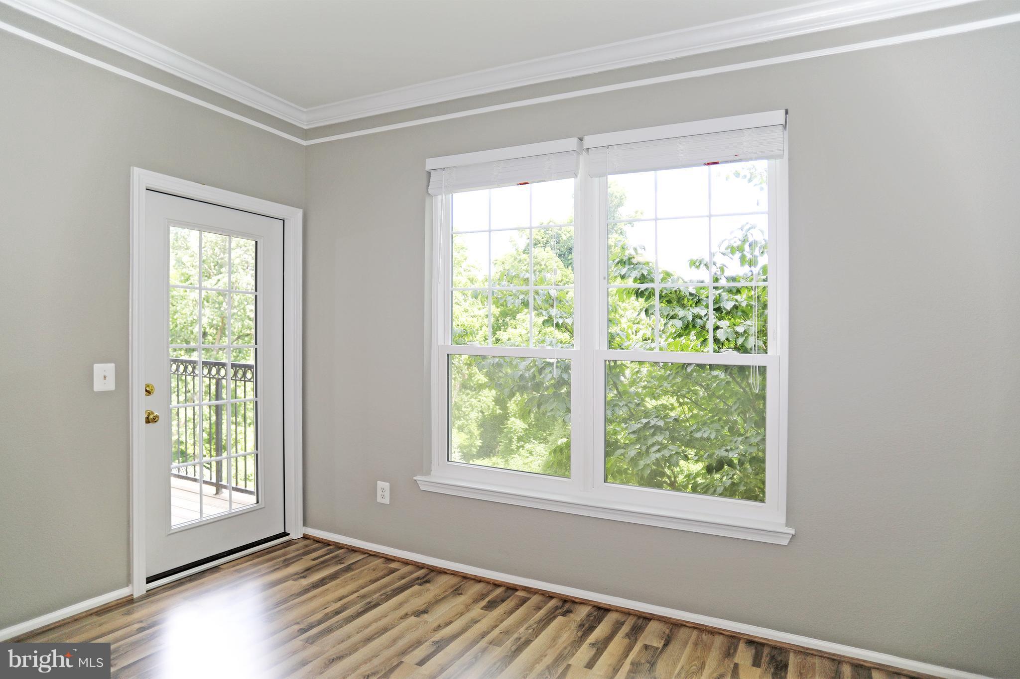 1601 Spring Gate Dr., Unit 1202 McLean, VA 22102 - Photo 7 of 30 a view of an empty room with wooden floor and a window