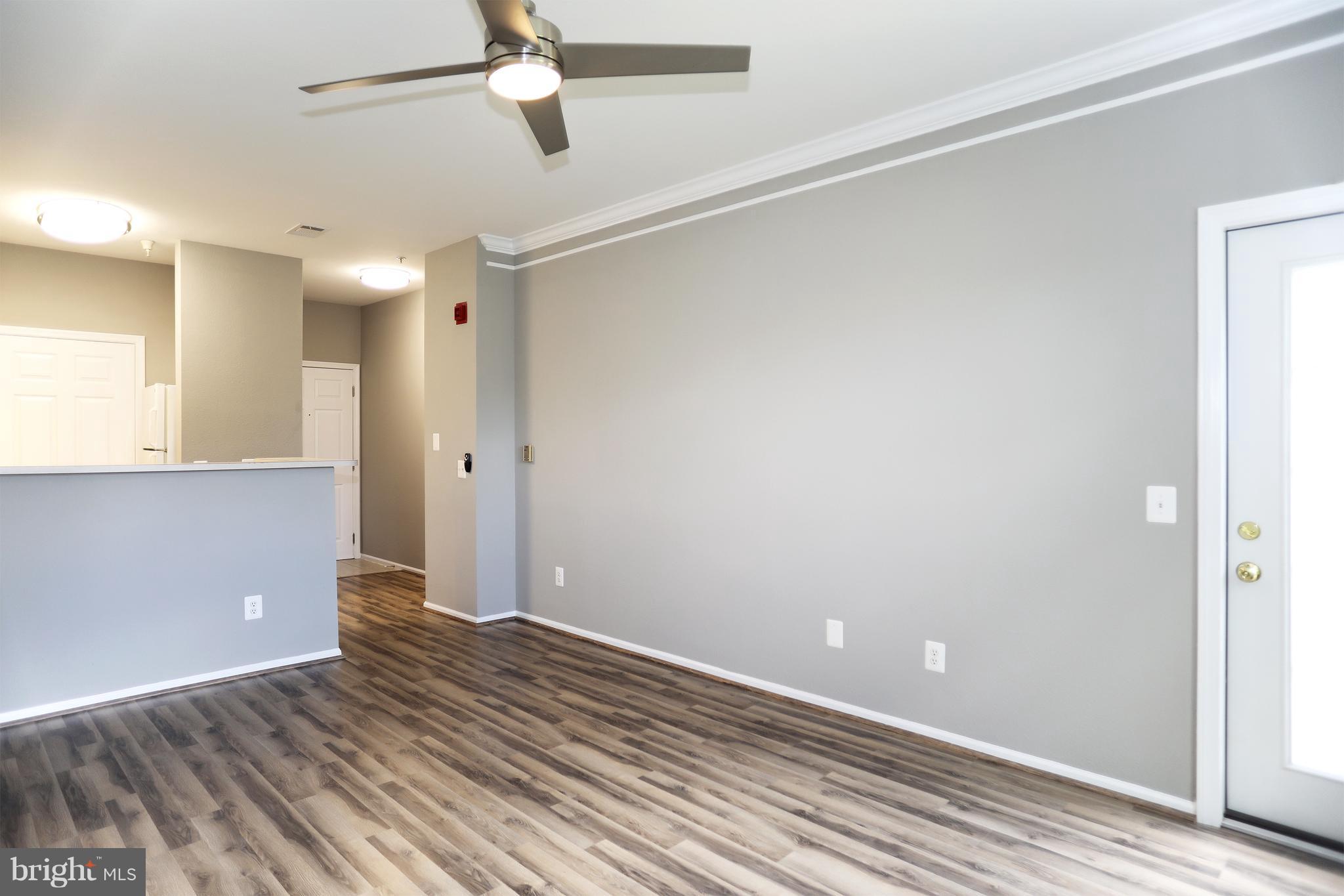 1601 Spring Gate Dr., Unit 1202 McLean, VA 22102 - Photo 10 of 30 wooden floor in an empty room with a window