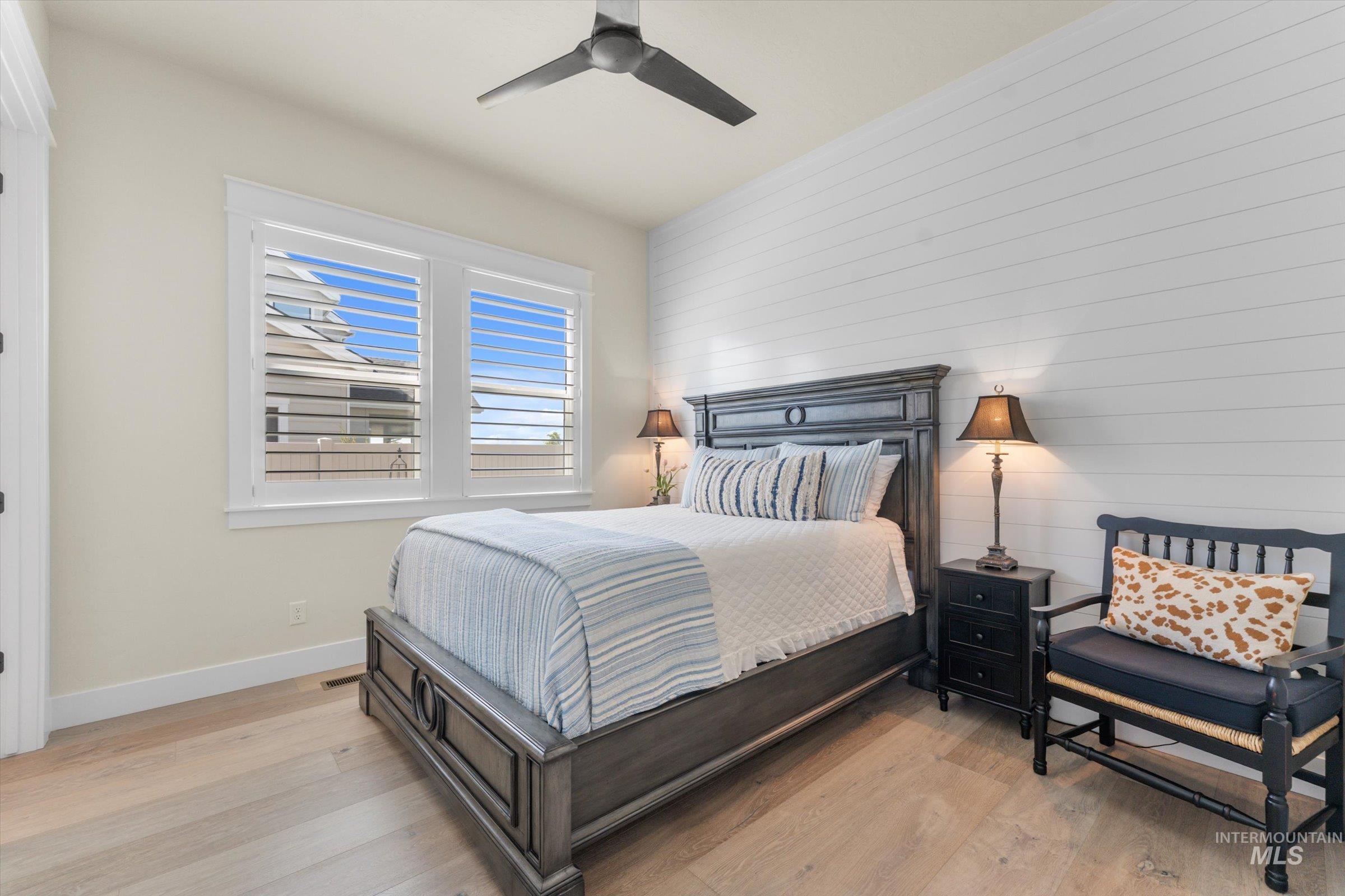 6585 South Pemberley Way Meridian, ID 83642 - Photo 32 of 43 Bedroom featuring light wood-finish flooring and a white shiplap accent wall