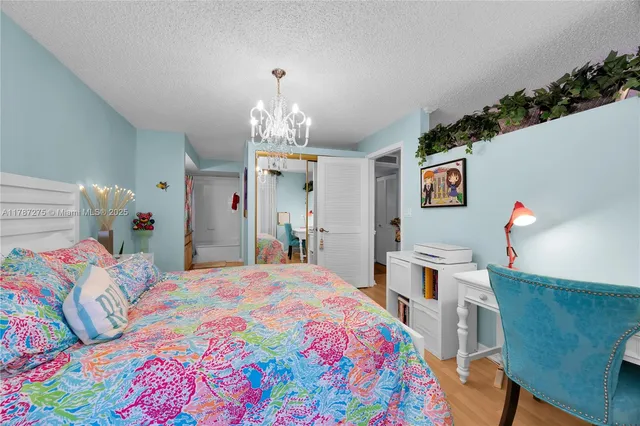 a bedroom that has a bed and a chandelier