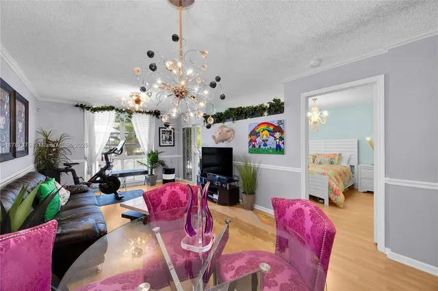 a living room with furniture a chandelier and a mirror