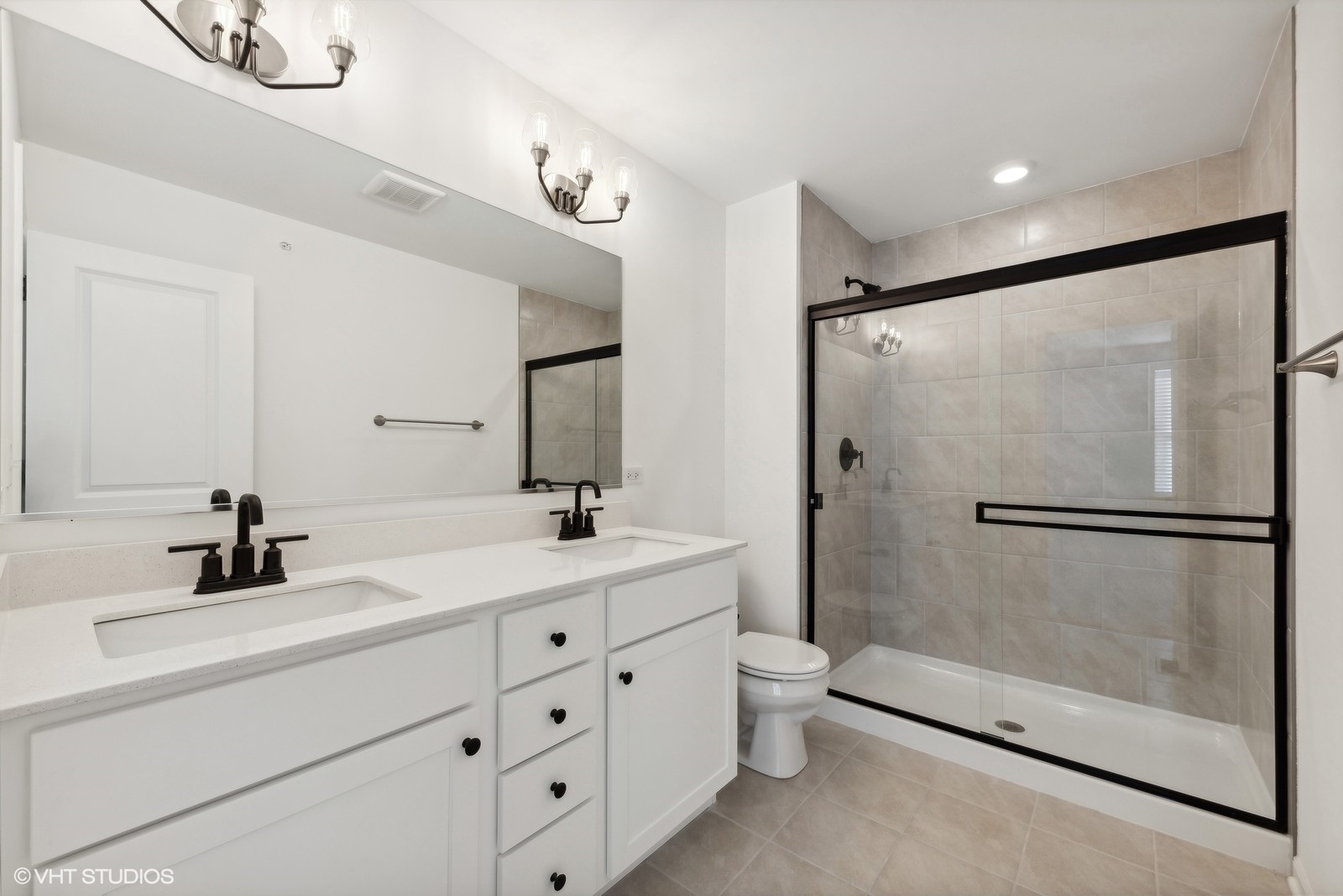 1033 Wren Road Des Plaines, IL 60018 - Photo 13 of 20 a bathroom with a double vanity sink toilet mirror and shower