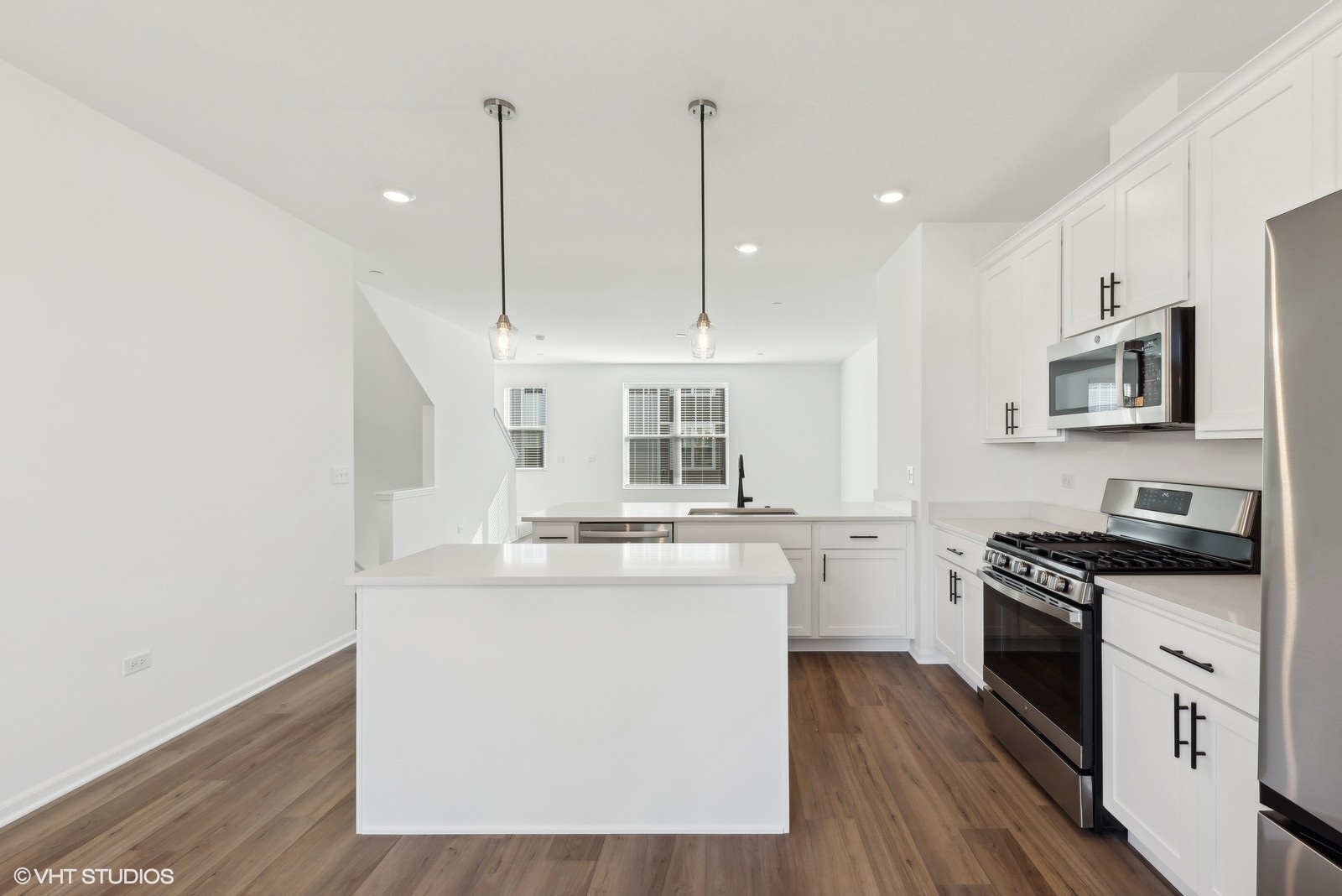 1033 Wren Road Des Plaines, IL 60018 - Photo 7 of 20 a kitchen with kitchen island granite countertop a sink cabinets and wooden floor