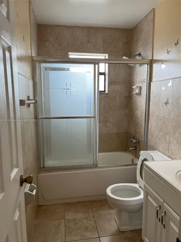 a bathroom with a toilet a sink and shower