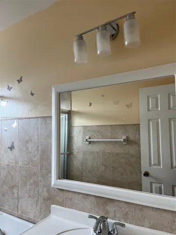 a bathroom with a shower and a sink
