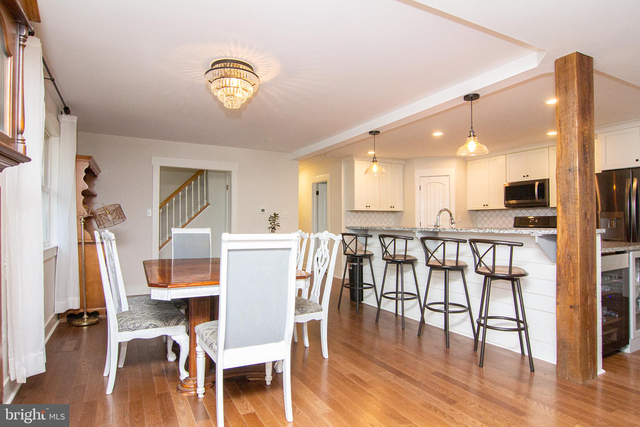 3061 Emmitsburg Road Gettysburg, PA 17325 - Photo 11 of 47 a dining room with furniture a floor to ceiling window and wooden floor